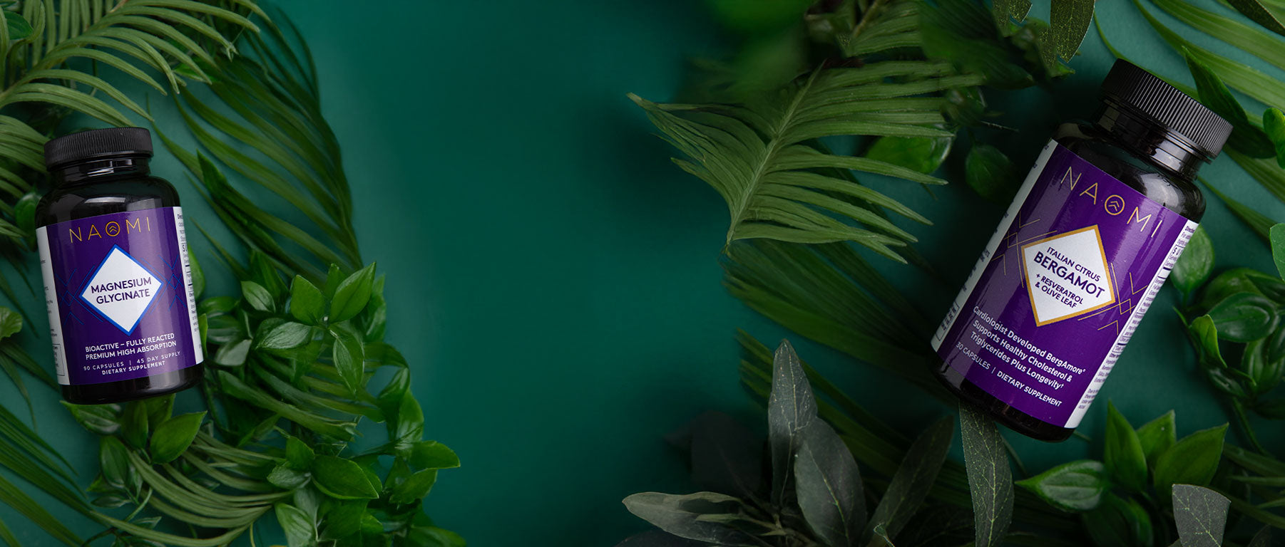 Two bottles of a Naomi supplements on a green leafy background