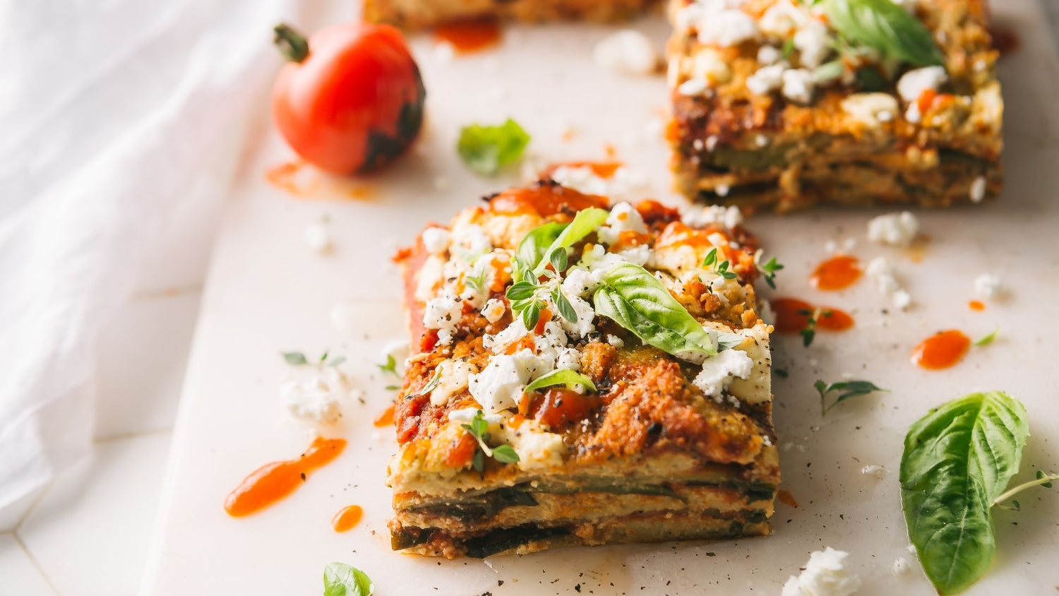 Glow15: Lasagna with Cashew Cheese, Garnished with Goat Cheese and Fresh Basil