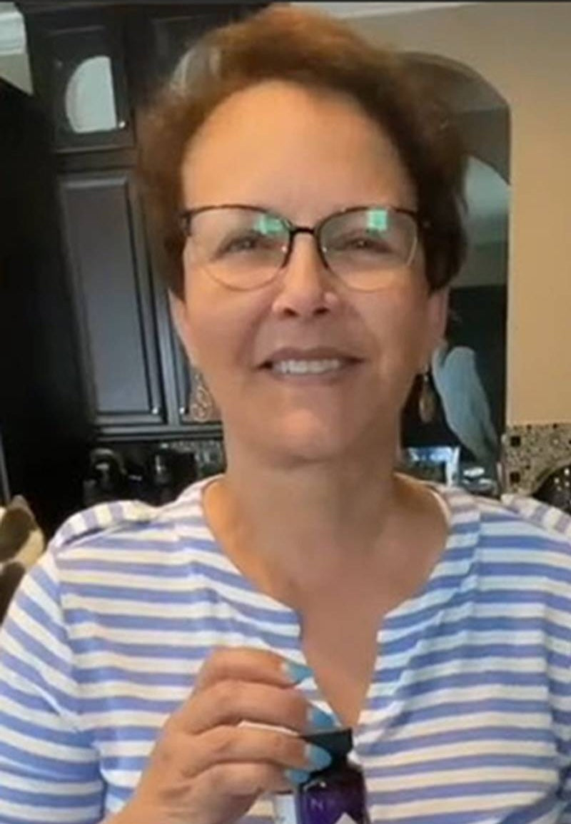Woman wearing glasses and a striped shirt indoors