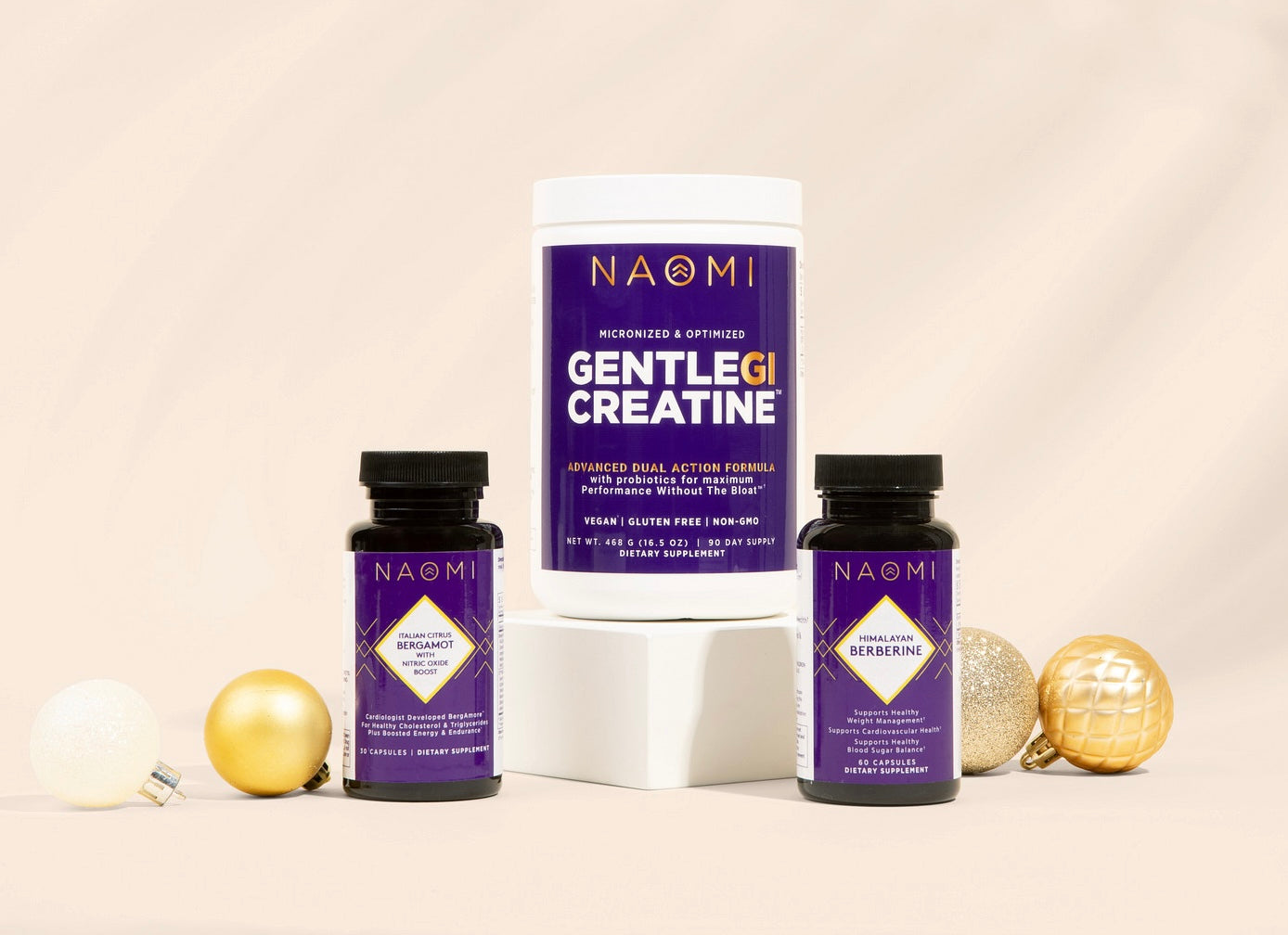 NAOMI GentleG Creatine supplement containers on a beige background with decorative elements.
