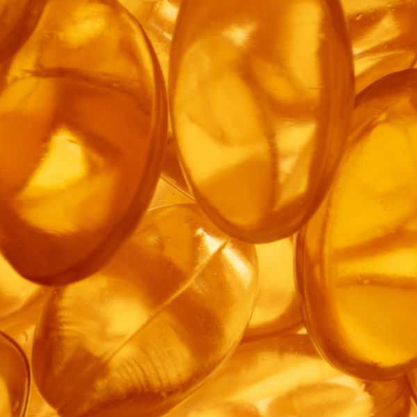 Close-up of multiple yellow-orange gel capsules.
