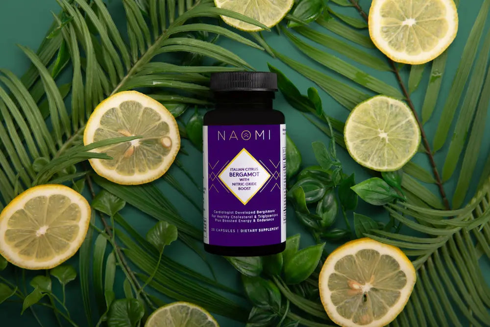 NAOMI bottle surrounded by lemon slices and green leaves on a textured surface