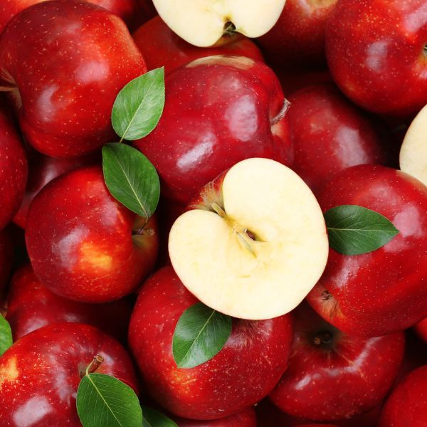 Red apples with a halved yellow apple on top