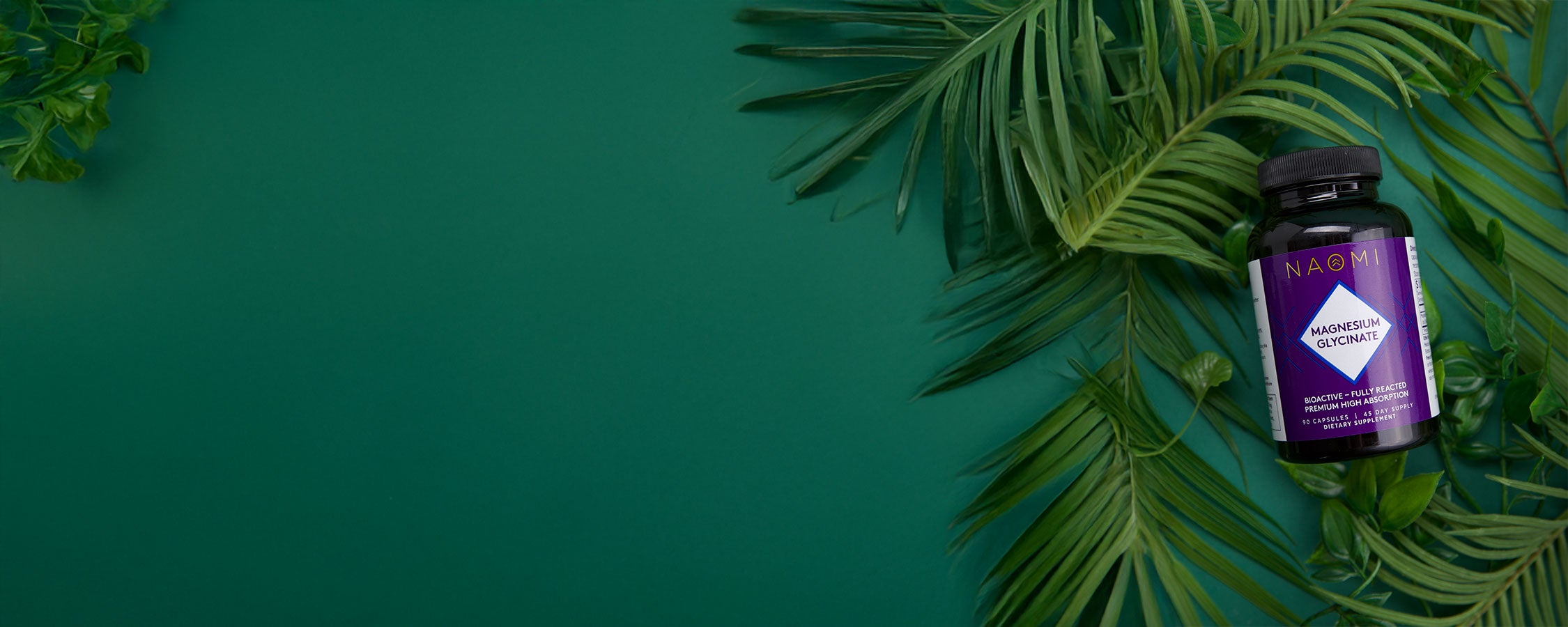 Purple supplement bottle on green leaves with a dark green background