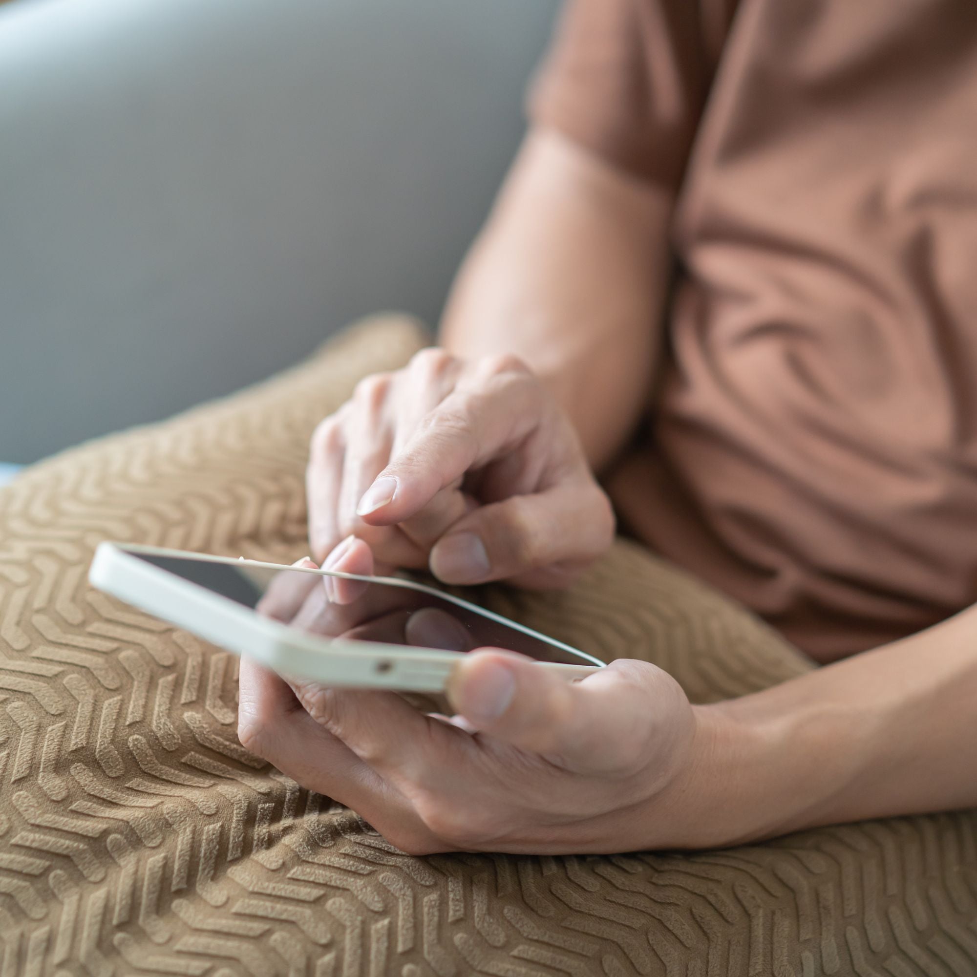 Person using a smartphone on a textured surface