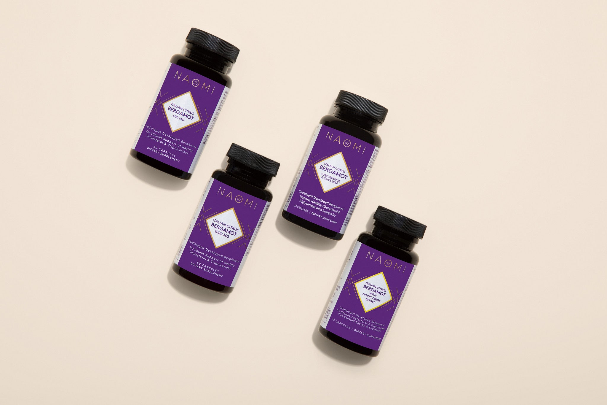 Four purple bottles with black caps on a beige background